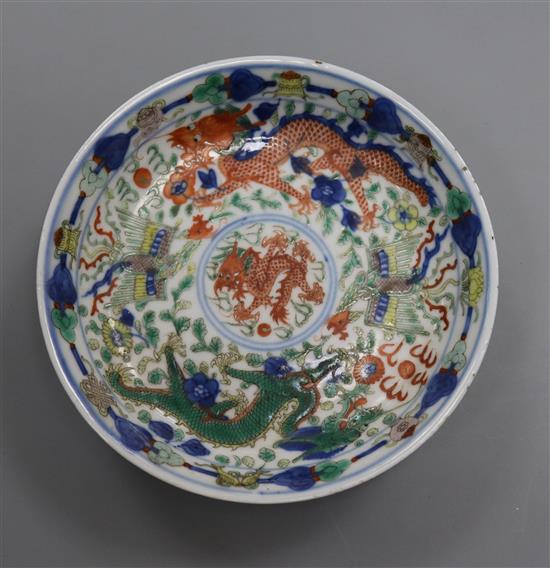 A Chinese wucai dragon and phoenix saucer dish, Kangxi mark, 19th century diameter 13.5cm